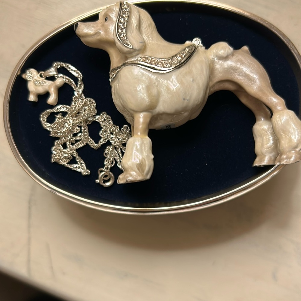 Adorable rhinestone encrusted ceramic poodle that opens to a necklace